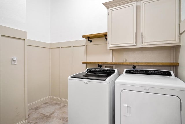 washroom featuring cabinets and washing machine and dryer