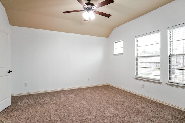 spare room with lofted ceiling, ceiling fan, and carpet