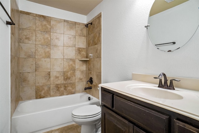 full bathroom featuring vanity, tile patterned flooring, toilet, and tiled shower / bath