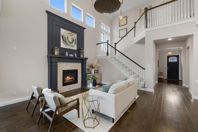 living room featuring dark hardwood / wood-style floors and a high ceiling