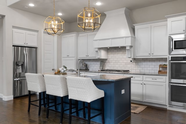 kitchen featuring stainless steel appliances, custom exhaust hood, sink, and white cabinets