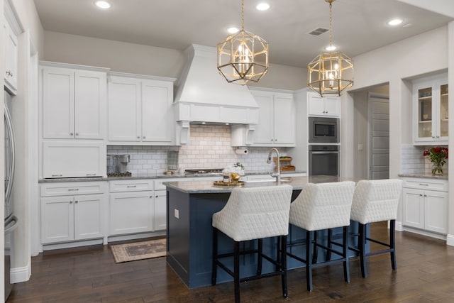 kitchen featuring sink, appliances with stainless steel finishes, white cabinetry, hanging light fixtures, and custom exhaust hood