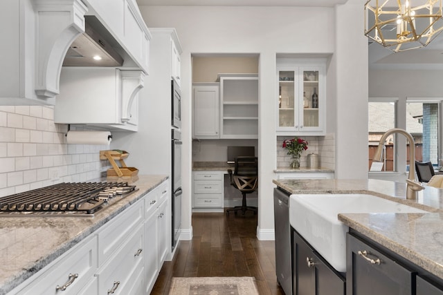 kitchen with dark wood-type flooring, white cabinetry, light stone counters, pendant lighting, and stainless steel appliances