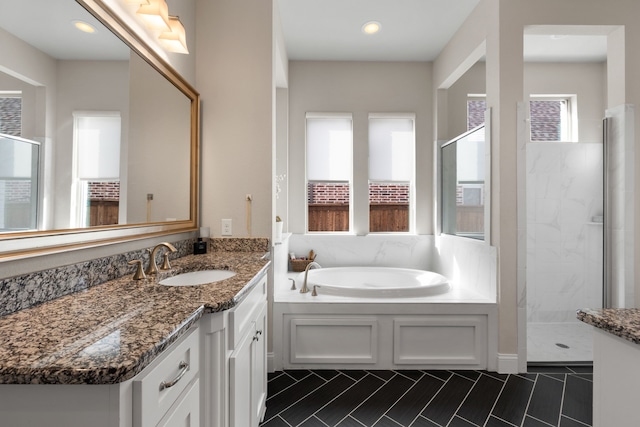 bathroom with plus walk in shower, vanity, and tile patterned floors