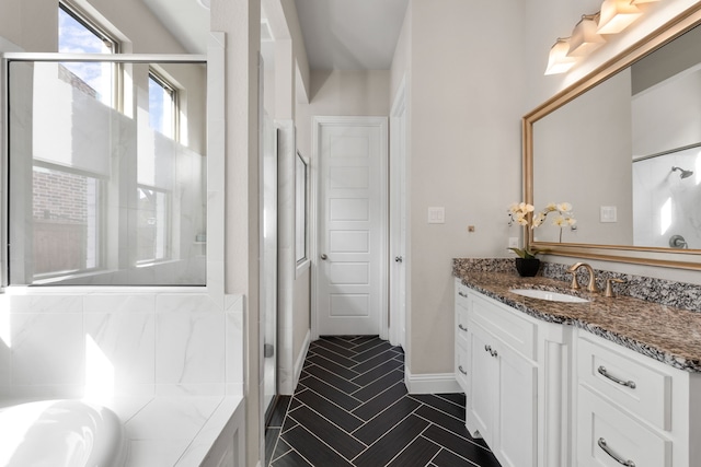 bathroom with vanity and shower with separate bathtub