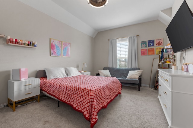 carpeted bedroom with lofted ceiling