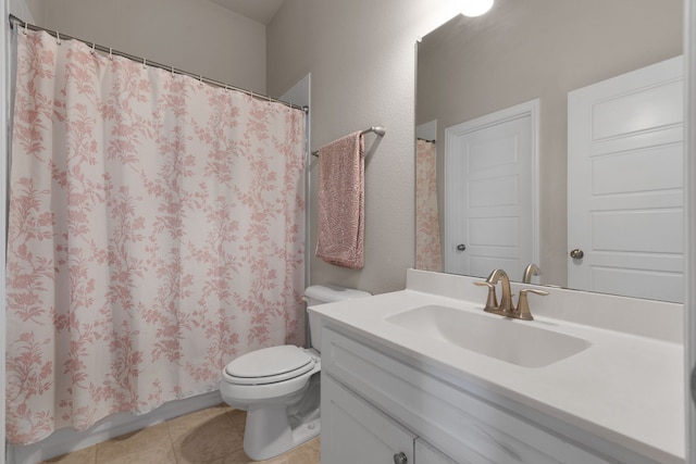 bathroom with vanity, toilet, and tile patterned flooring