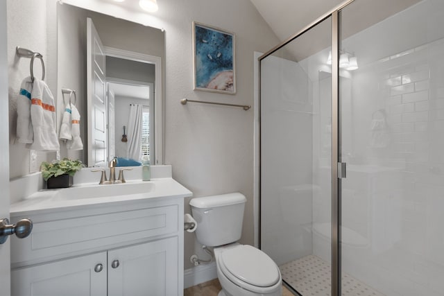 bathroom featuring walk in shower, vaulted ceiling, vanity, and toilet