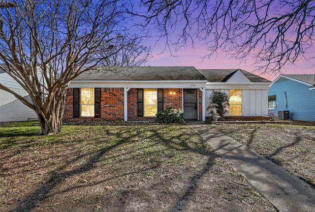 ranch-style house with central AC and a yard