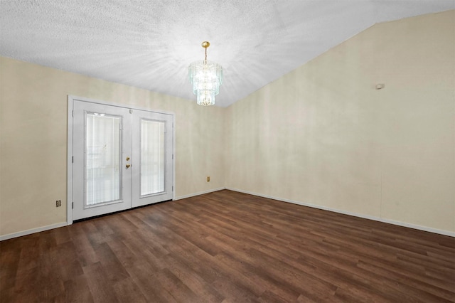 empty room with french doors, dark hardwood / wood-style flooring, a chandelier, and a textured ceiling