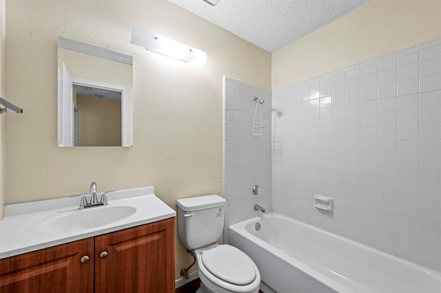 full bathroom featuring vanity, toilet, a textured ceiling, and shower / bathing tub combination