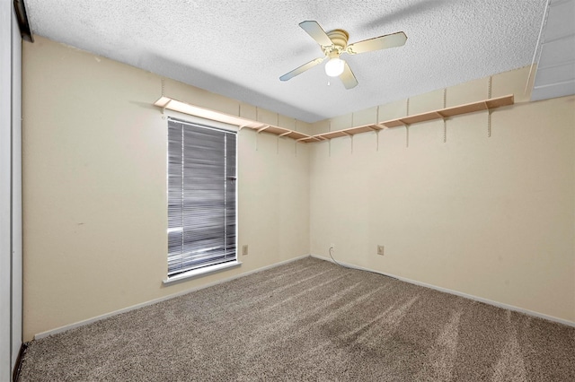 carpeted empty room featuring a textured ceiling and ceiling fan