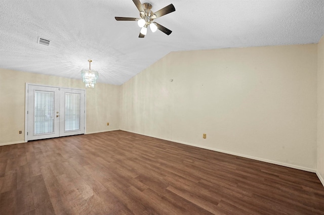 unfurnished room with dark wood-type flooring, ceiling fan with notable chandelier, a textured ceiling, and french doors