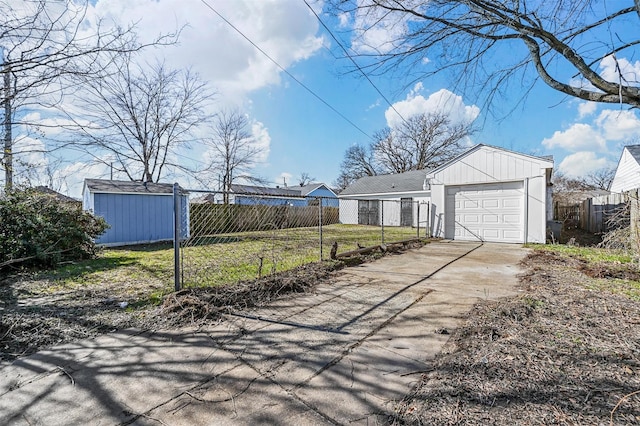 exterior space with a garage, a front yard, and a storage unit