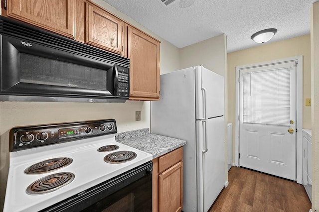 kitchen with range with electric cooktop, dark hardwood / wood-style floors, a textured ceiling, and white refrigerator