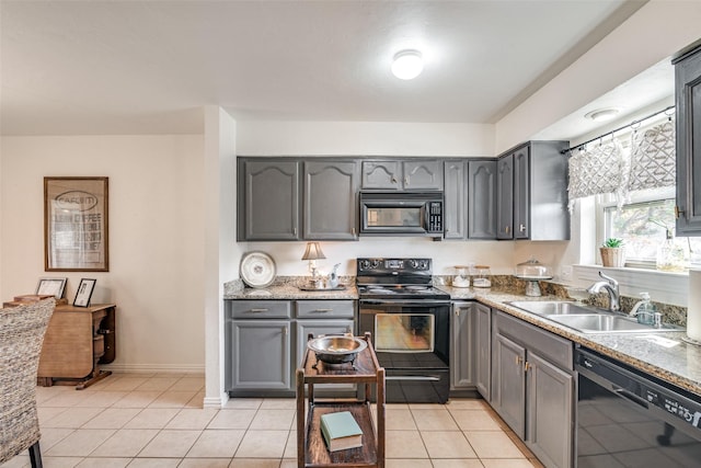 kitchen featuring light tile patterned flooring, gray cabinets, sink, and black appliances