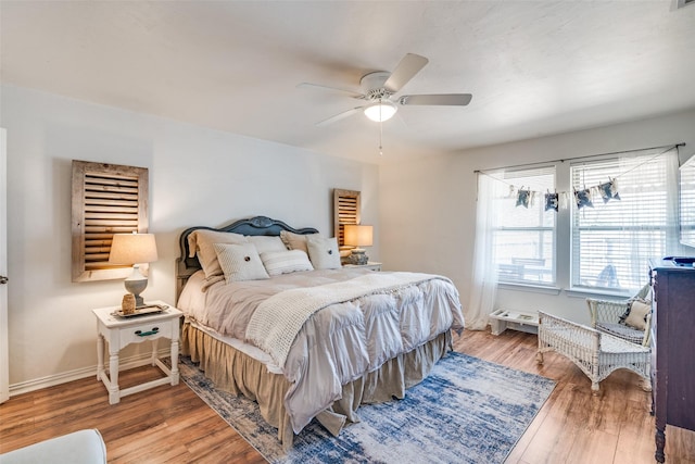 bedroom with hardwood / wood-style floors and ceiling fan