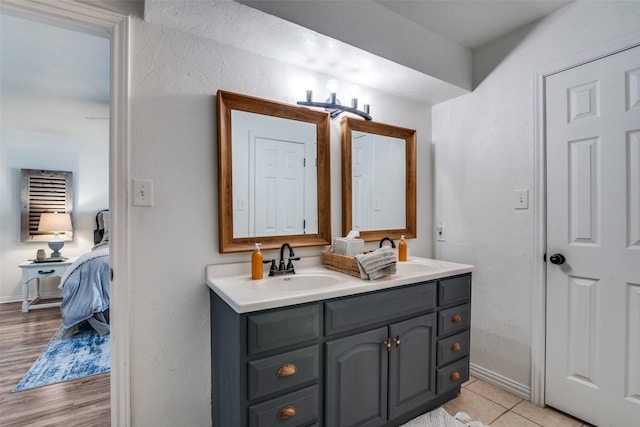 bathroom featuring tile patterned flooring and vanity