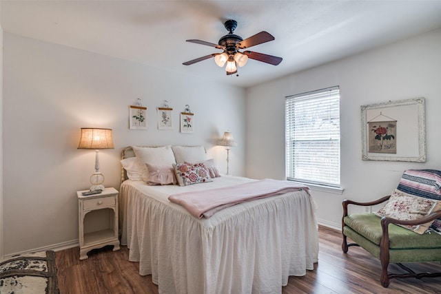 bedroom with ceiling fan and dark hardwood / wood-style floors