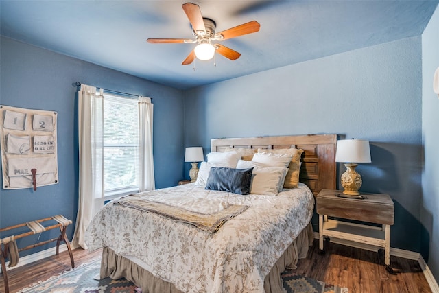 bedroom featuring dark hardwood / wood-style flooring and ceiling fan