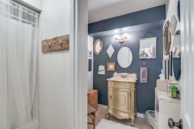 bathroom featuring tile patterned flooring, vanity, and curtained shower