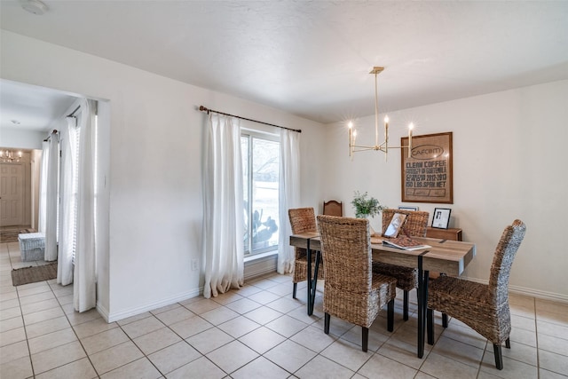 tiled dining room featuring a notable chandelier