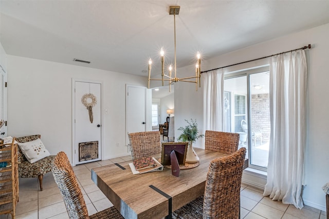 dining room featuring light tile patterned flooring and a chandelier