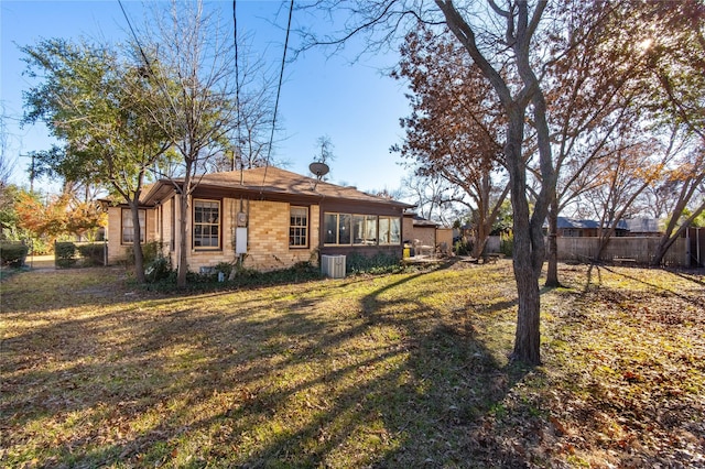 rear view of property with a yard