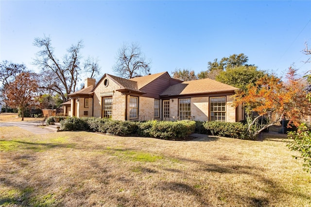 view of side of property with a yard