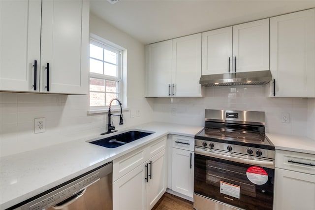 kitchen featuring sink, white cabinets, stainless steel appliances, light stone countertops, and backsplash