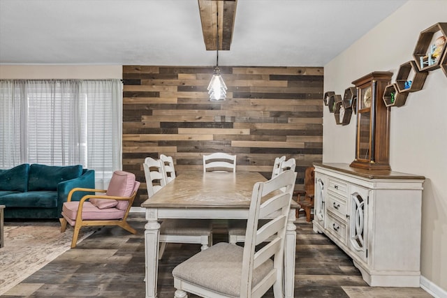 dining room with dark wood-type flooring and wood walls