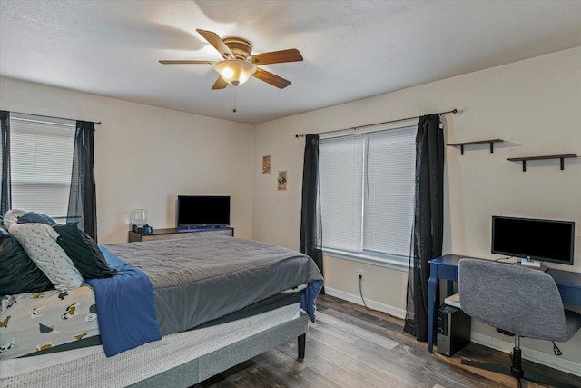 bedroom with ceiling fan and wood-type flooring