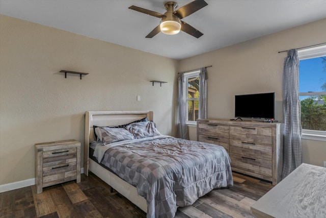 bedroom with ceiling fan and dark hardwood / wood-style flooring