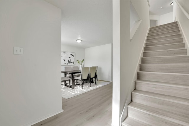 staircase featuring hardwood / wood-style floors