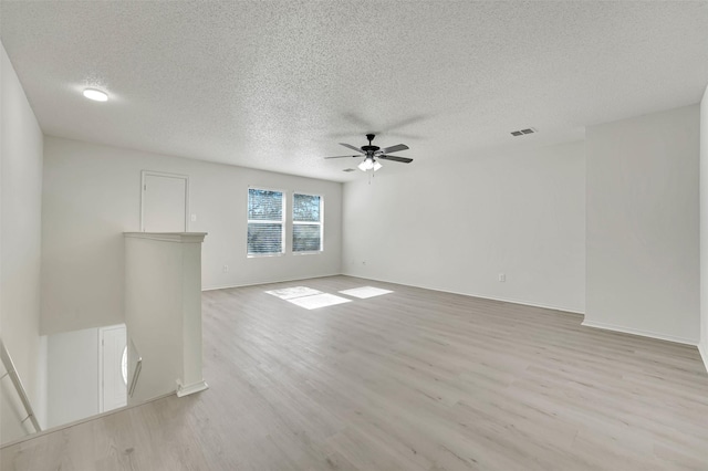 unfurnished living room with a textured ceiling, ceiling fan, and light wood-type flooring