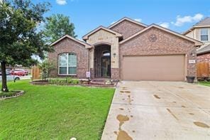 view of front of home with a garage and a front lawn