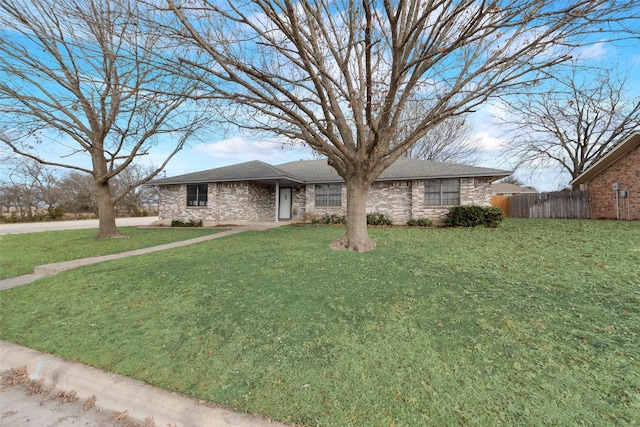 ranch-style home featuring a front yard