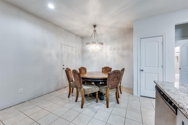 tiled dining space with a chandelier