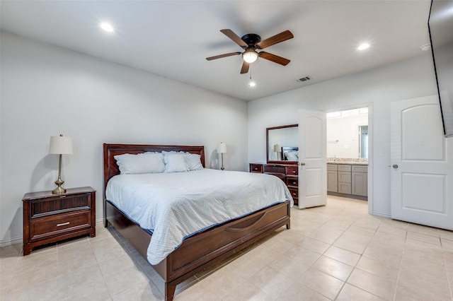 tiled bedroom with ceiling fan and ensuite bath