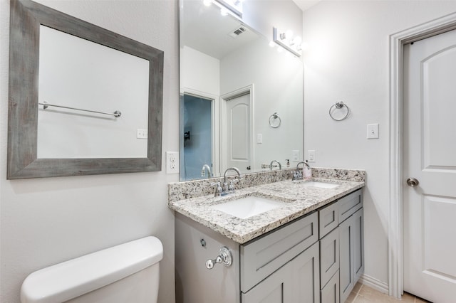 bathroom with vanity and toilet