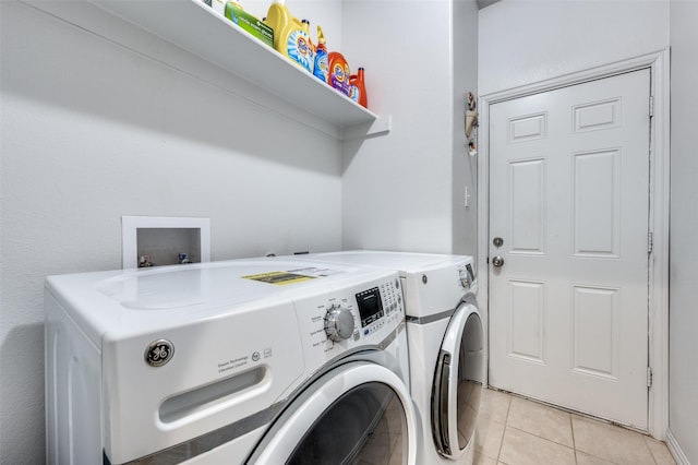 laundry room with separate washer and dryer and light tile patterned floors