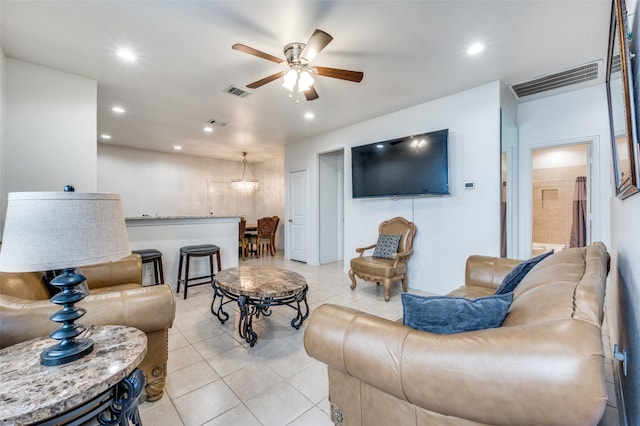 tiled living room with ceiling fan