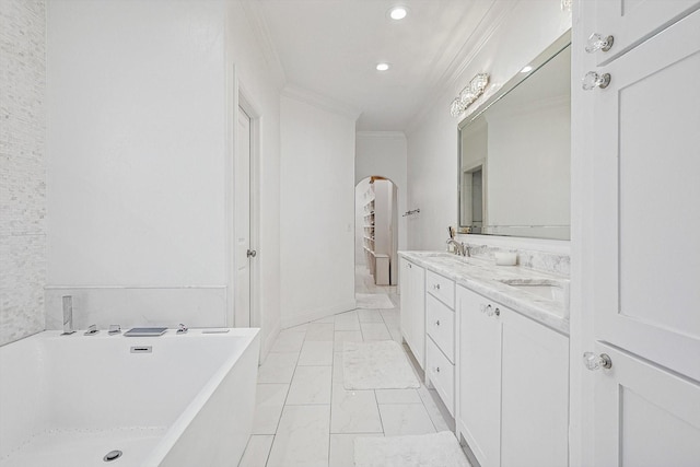 bathroom featuring vanity, a bath, and ornamental molding