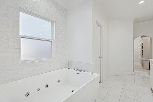 bathroom featuring a tub to relax in and crown molding