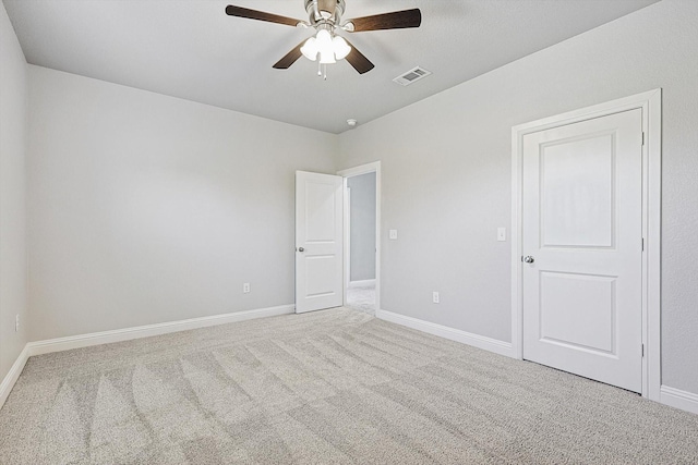 carpeted spare room with ceiling fan