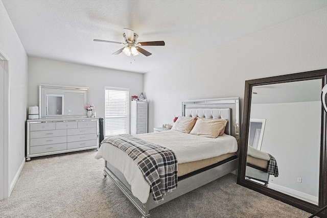 bedroom featuring ceiling fan, carpet floors, and a textured ceiling