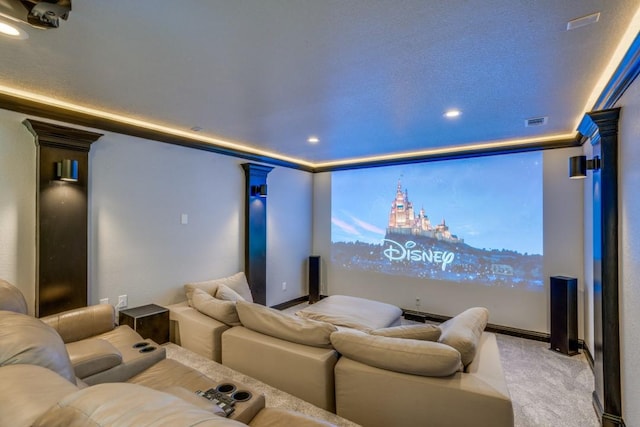 carpeted cinema room featuring decorative columns