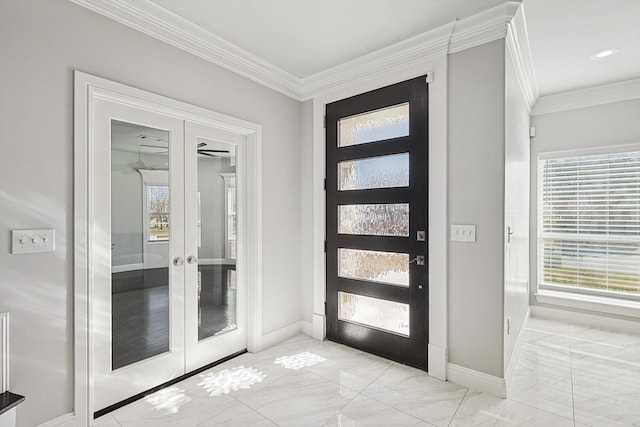 foyer featuring ornamental molding, french doors, and a healthy amount of sunlight