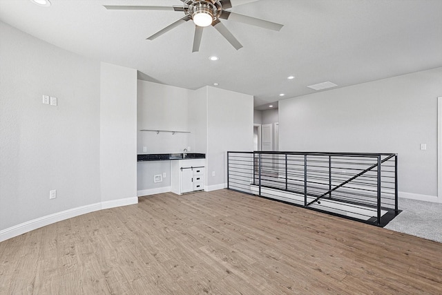 unfurnished room with ceiling fan and light wood-type flooring