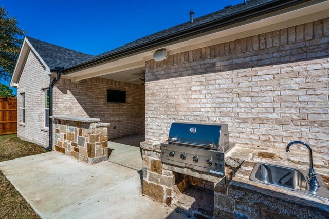 view of patio / terrace with ceiling fan, grilling area, exterior kitchen, and sink